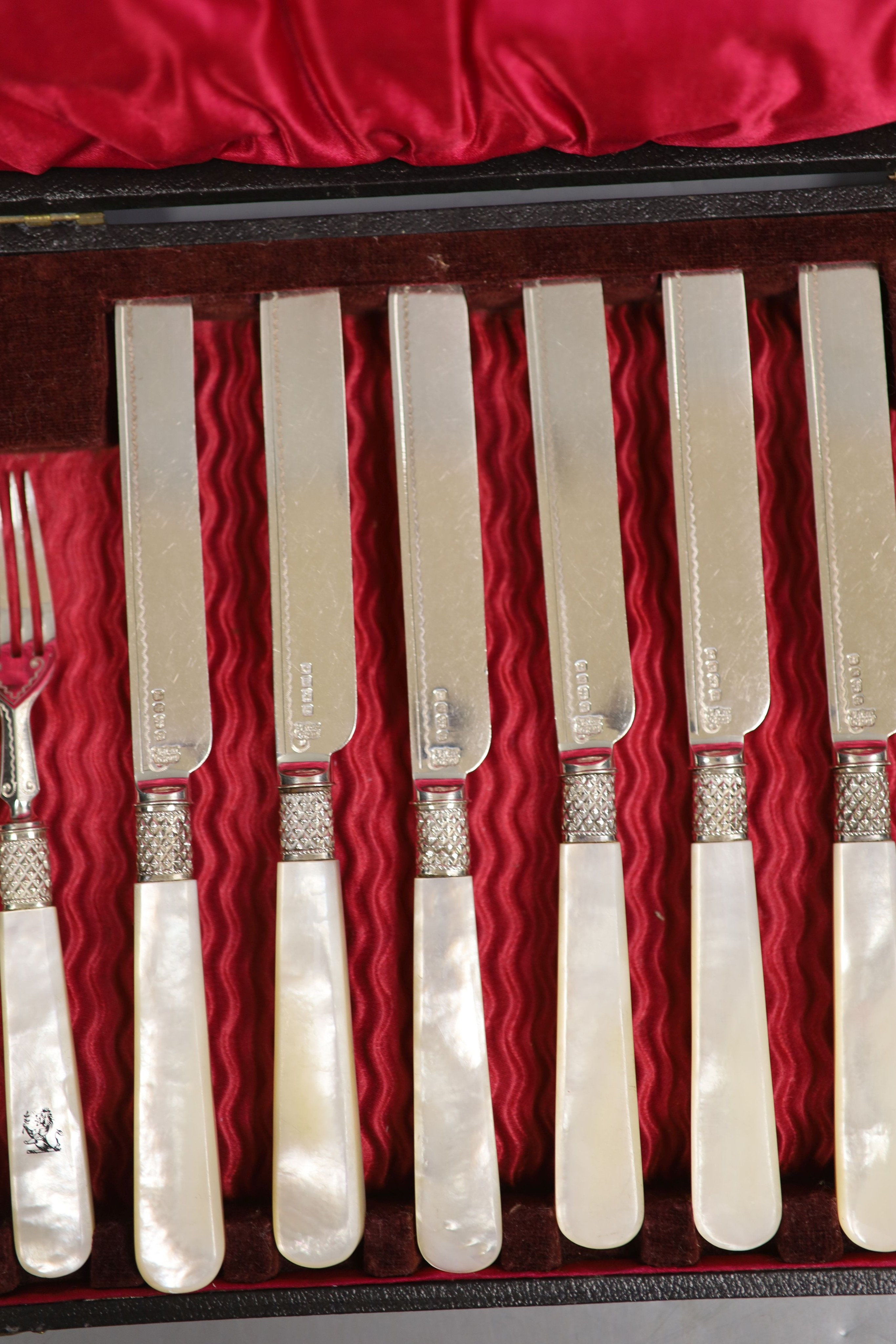 A cased set of six pairs of mother of pearl handled dessert eaters, Mappin & Webb, Sheffield, 1880, case 34cm.